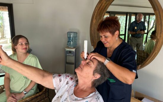 Local optician , Leoni Joubert, supporting the Tshemba Foundation conducting an eye test